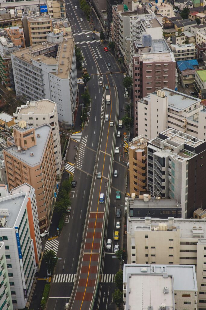 Modern city with road surrounded with tall residential buildings